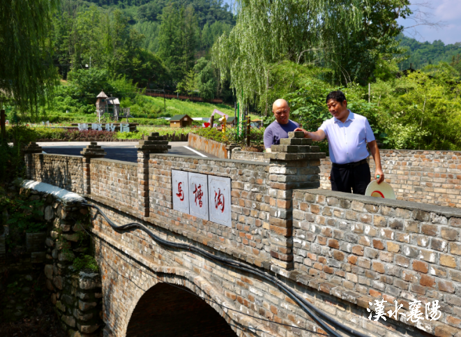 ▲堰河村党委书记、村委会主任闵洪艳向余村村党支部书记、村委会主任汪玉成介绍乡村规划