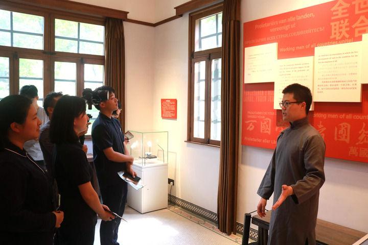 在上海复旦大学《共产党宣言》展示馆,“星火”党员志愿服务队志愿者(右一)为观众讲解(2024年5月26日摄)。新华社发